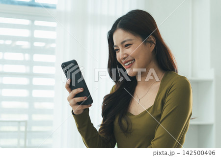 Young Asian Woman Studying Online with Laptop, Tablet, Smartphone and Headphones at Home, Adult Education and E-Learning Young Asian Woman Studying Online with Laptop, Tablet, Smartphone and Headphones at Home, Adult Education and E-Learning 142500496