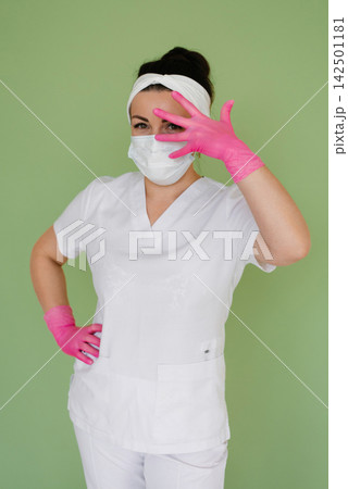 Professional Medic in White Suit and Pink Gloves Professional Medic in White Suit and Pink Gloves 142501181