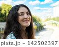 Happy adult female looking at camera outdoors, copy space for text 142502397