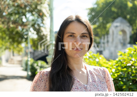 Portrait of attractive 34 year old brunette woman smiling gently in park Portrait of attractive 34 year old brunette woman smiling gently in park 142502412
