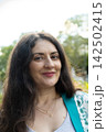 Portrait of attractive 38 year old Armenian woman smiling happily in park 142502415