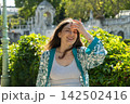 Happy Adult Woman with Long Brown Hair Enjoying Warm Summer Weather Outdoors 142502416