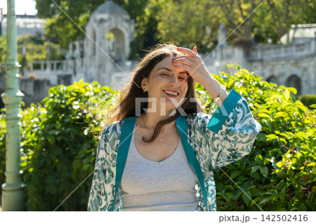 Happy Adult Woman with Long Brown Hair Enjoying Warm Summer Weather Outdoors Happy Adult Woman with Long Brown Hair Enjoying Warm Summer Weather Outdoors 142502416
