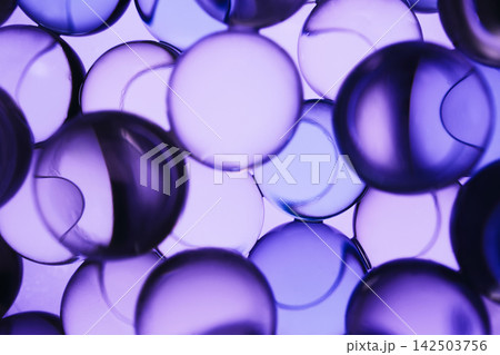 Multiple transparent liquid spheres creating vibrant purple science abstract background Multiple transparent liquid spheres creating vibrant purple science abstract background 142503756