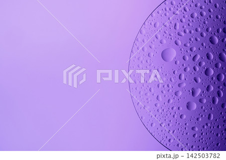 Water drops on glass slide, forming an abstract purple pattern Water drops on glass slide, forming an abstract purple pattern 142503782
