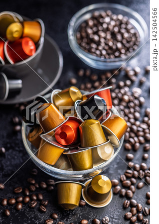 Colorful Coffee Capsules And Coffee Beans In Glass Bowls With Espresso Pods For Home Brewing Colorful Coffee Capsules And Coffee Beans In Glass Bowls With Espresso Pods For Home Brewing 142504566