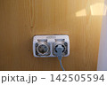 Dirty Electrical Wall Socket with Black Grime Dust and Stains Around Plug Showing Neglected Outlet and Poor Household Cleaning 142505594