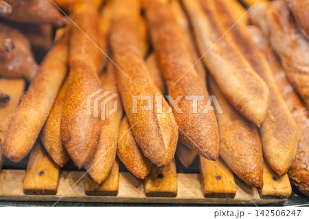 Golden Brown Baguettes on Wooden Bakery Rack 142506247