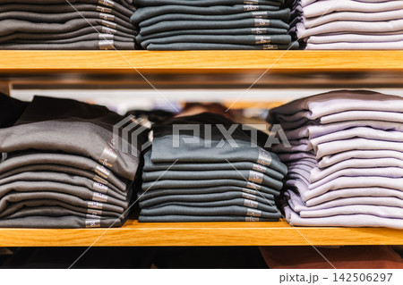 Neatly Folded Shirts on Wooden Retail Shelves Neatly Folded Shirts on Wooden Retail Shelves 142506297