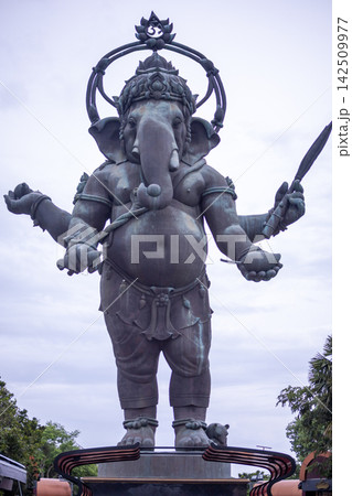 Large standing Lord Ganesha bronze sculpture against blue sky, famous landmark in Chachoengsao, Thailand Large standing Lord Ganesha bronze sculpture against blue sky, famous landmark in Chachoengsao, Thailand 142509977