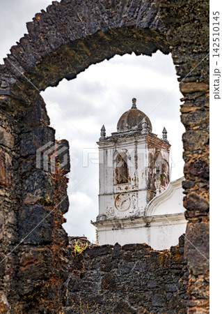 Church tower through the stone ruins 142510145
