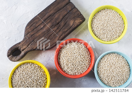 organic quinua cereal in color bowl on white background organic quinua cereal in color bowl on white background 142511784