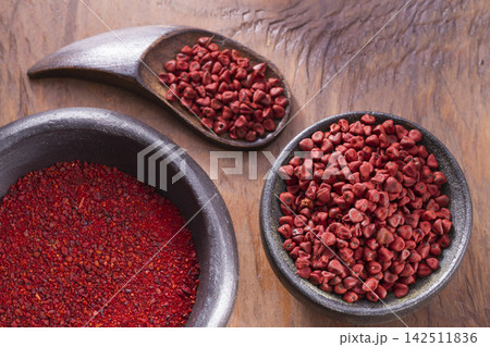 achiote in bowl on wooden background, achiote paste achiote in bowl on wooden background, achiote paste 142511836