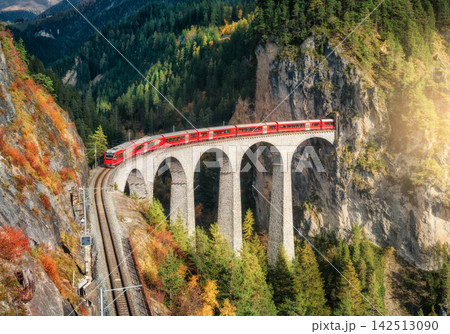 Aerial view of modern red train on Landwasser viaduct Aerial view of modern red train on Landwasser viaduct 142513090