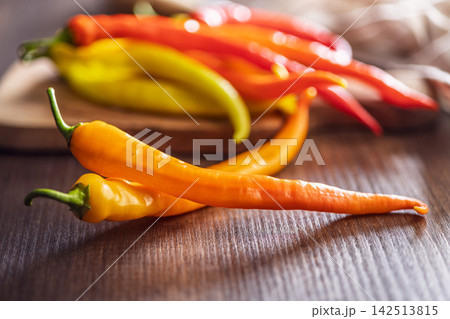 Colorful Hot Chili Peppers on Wooden Table for Cooking, Spices and Fresh Produce 142513815