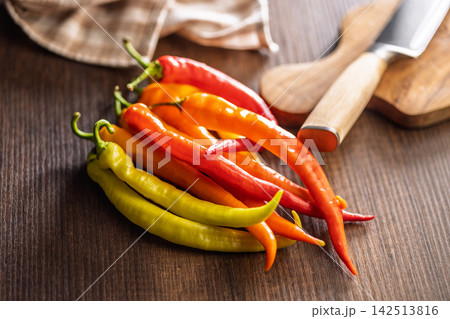 Colorful Hot Chili Peppers on Wooden Table for Cooking, Spices and Fresh Produce Colorful Hot Chili Peppers on Wooden Table for Cooking, Spices and Fresh Produce 142513816