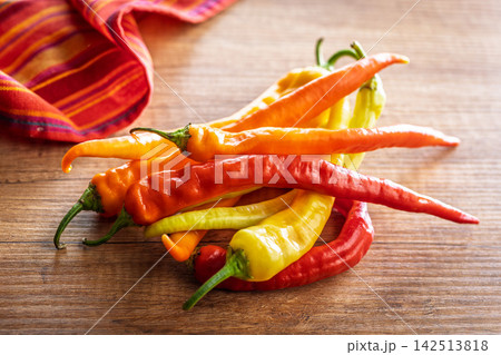 Colorful Hot Chili Peppers on Wooden Table for Cooking, Spices and Fresh Produce Colorful Hot Chili Peppers on Wooden Table for Cooking, Spices and Fresh Produce 142513818