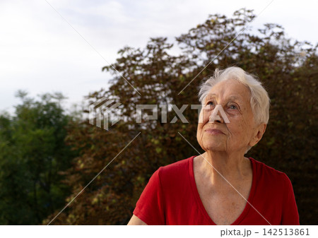 Portrait of old senior woman at balcony Portrait of old senior woman at balcony 142513861