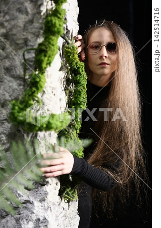 Focused scientist analyzing layered mineral deposits under bright lighting 142514716