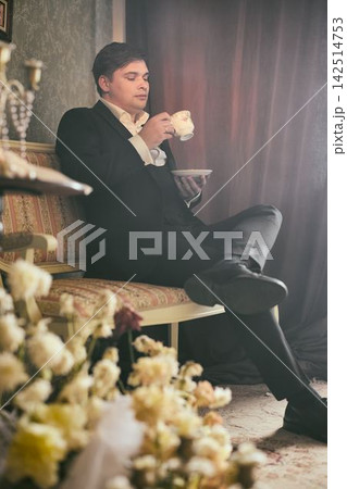 Poignant scene of author surrounded by flowers and tranquil setting 142514753
