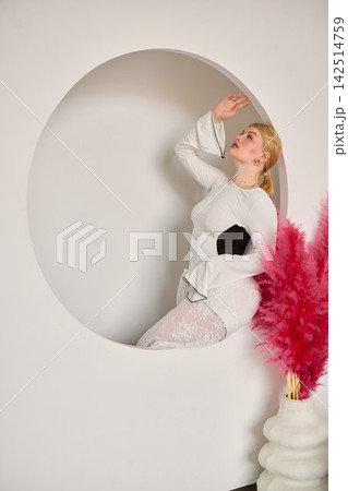 Stylish female model posed gracefully with muted colors and textures Stylish female model posed gracefully with muted colors and textures 142514759