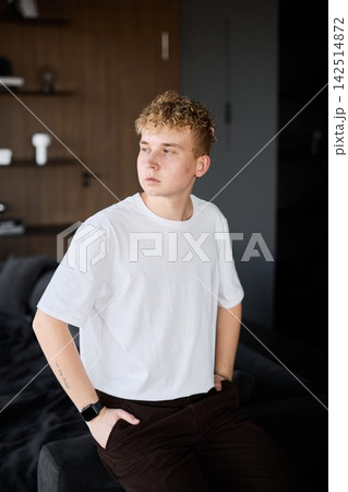 Lively young male quietly considering his thoughts and emotions Lively young male quietly considering his thoughts and emotions 142514872