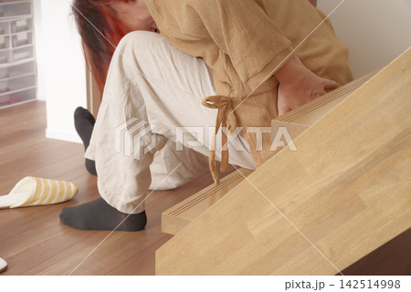 階段で転んで腰まわりを痛めたシニア女性 142514998