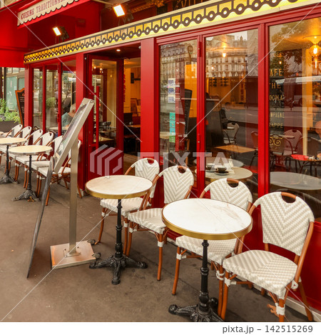 Traditional parisian bistro facade with outdoor tables and chairs, inviting guests for a classic french experience Traditional parisian bistro facade with outdoor tables and chairs, inviting guests for a classic french experience 142515269