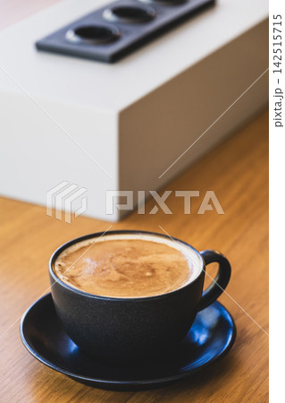 Fresh Coffee in Black Cup on Office Table. 142515715