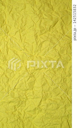 bright yellow crumpled paper background with deep creases vivid textured surface for backdrop 142515832
