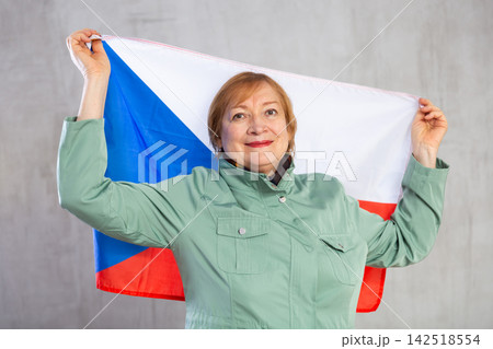 Cheerful senior woman holding flag of Czech Republic Cheerful senior woman holding flag of Czech Republic 142518554