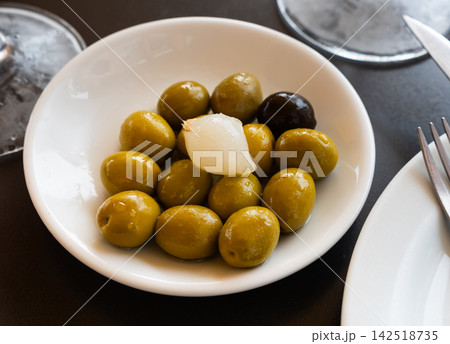 Light snack - oval bowl with pickled green olives and small onion Light snack - oval bowl with pickled green olives and small onion 142518735
