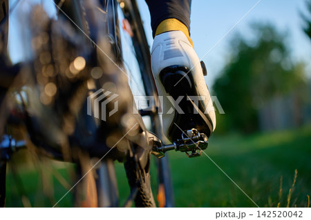 Close-up of a cyclist shoe clipped into the bike pedal. Close-up of a cyclist shoe clipped into the bike pedal. 142520042