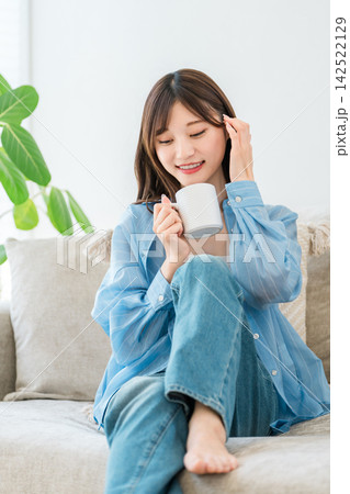 温かい飲み物で温活を楽しむ女性。美容と冷え対策を意識したリラックスタイム 温かい飲み物で温活を楽しむ女性。美容と冷え対策を意識したリラックスタイム 142522129