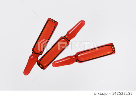 Three medical ampoules with red-orange solution for pharmaceutical use Three medical ampoules with red-orange solution for pharmaceutical use 142522153