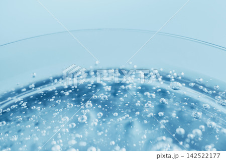 Tiny carbonated bubbles rising in clear clean refreshing water showing purity Tiny carbonated bubbles rising in clear clean refreshing water showing purity 142522177