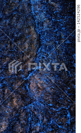 Mixing alcohol ink in macro shot revealing vibrant blue patterns 142524296