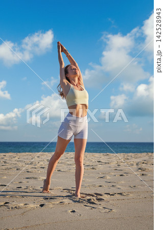 Upward Salute with joined palms beneath a blue sky 142528943