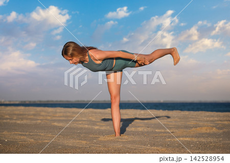 Virabhadrasana 3 yoga variation with arms reaching backward Virabhadrasana 3 yoga variation with arms reaching backward 142528954