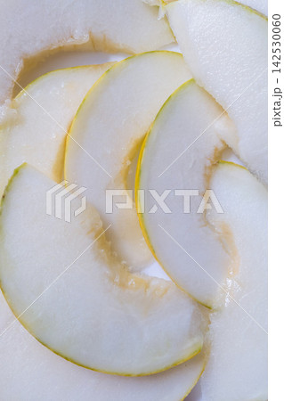 Fresh juicy yellow melon slices arranged on white background top view 142530060