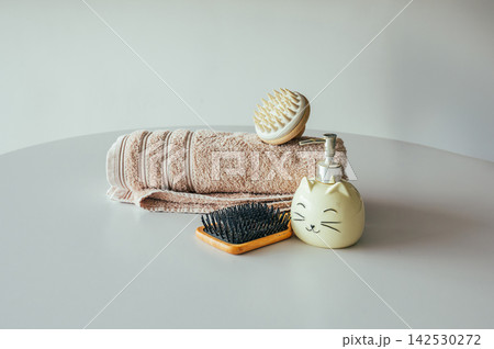 Rolled towel and grooming tools minimalist beauty flat lay 142530272