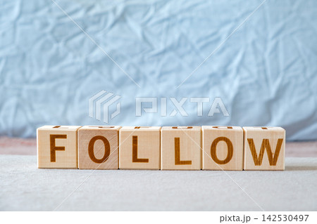 motivational word Follow is laid out from letters on wooden cubes motivational word Follow is laid out from letters on wooden cubes 142530497