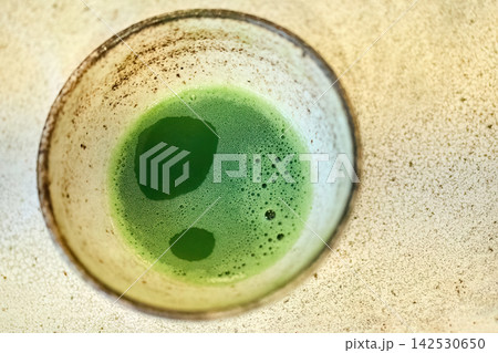 Matcha green tea in ceramic bowl preparing healthy drink Matcha green tea in ceramic bowl preparing healthy drink 142530650