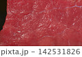 Extreme macro shot of fresh raw beef meat surface, glistening red muscle fibers and fine connective tissue texture 142531826