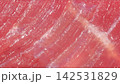 Macro full frame shot of raw beef muscle grain texture, fine marbling connective tissue and glistening red meat fibers 142531829