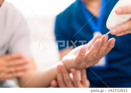 Medical worker checking blood sugar level of senior man at home Medical worker checking blood sugar level of senior man at home 142532631