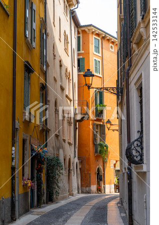 Narrow Street with Colorful Historic Buildings, Shutters and Lanterns in Verona Old Town, Italy 142533144