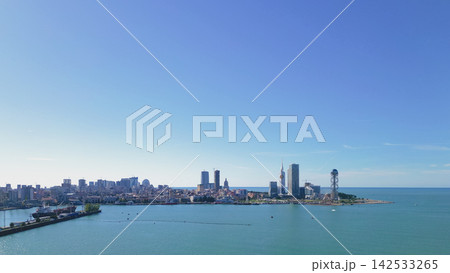 Panoramic view of Batumi city skyline with modern architecture, coastline, and clear blue sky, showcasing the Black Sea and urban landscape of Georgia 142533265