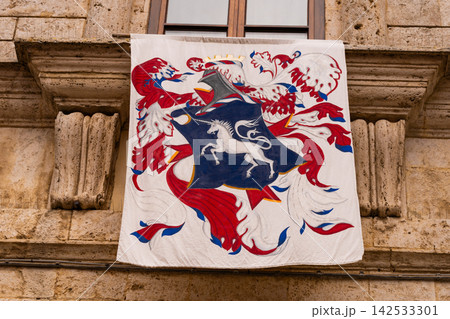 Heraldic banner with unicorn emblem on historic building facade Heraldic banner with unicorn emblem on historic building facade 142533301