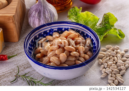 White beans in blue patterned ceramic bowl with garlic rosemary and fresh greens White beans in blue patterned ceramic bowl with garlic rosemary and fresh greens 142534127